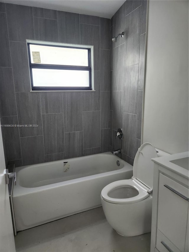 full bathroom featuring toilet, vanity, and tiled shower / bath