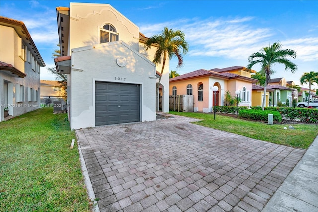 view of front of property featuring a garage and a front yard