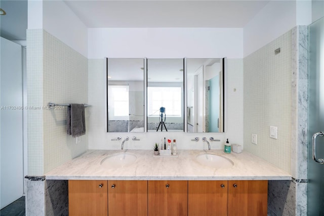 bathroom featuring backsplash, vanity, and an enclosed shower