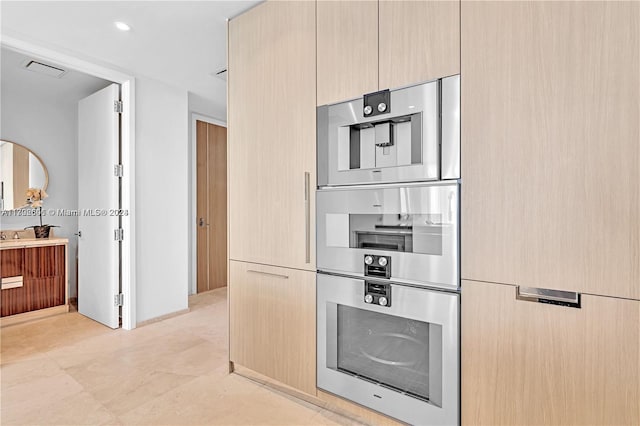 15701 Collins Ave Unit 703, Sunny Isles Beach, FL 33160 - kitchen with modern cabinets, stainless steel double oven, and light brown cabinets