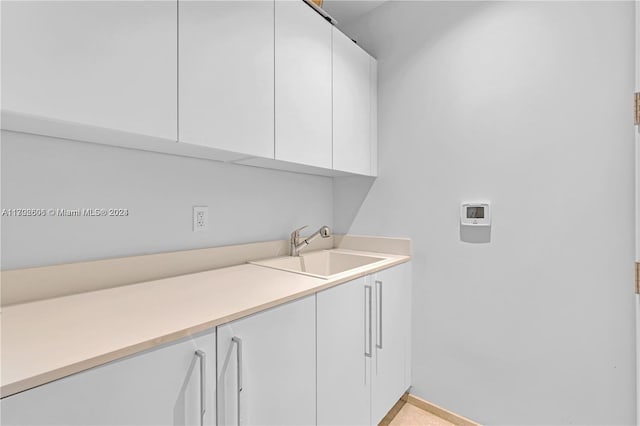 15701 Collins Ave Unit 703, Sunny Isles Beach, FL 33160 - washroom with cabinet space and baseboards