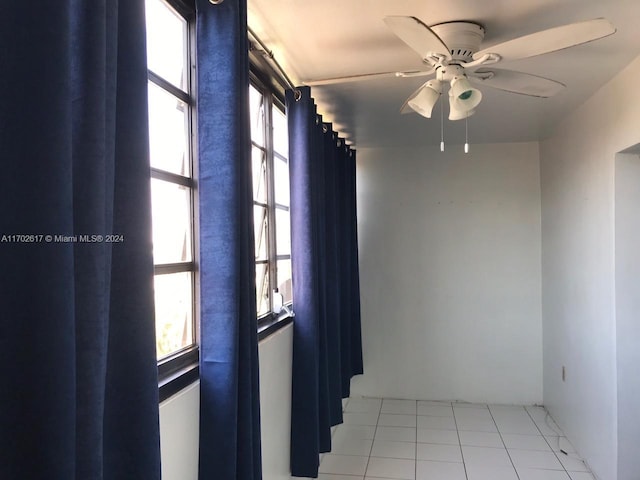 unfurnished room featuring ceiling fan and light tile patterned floors