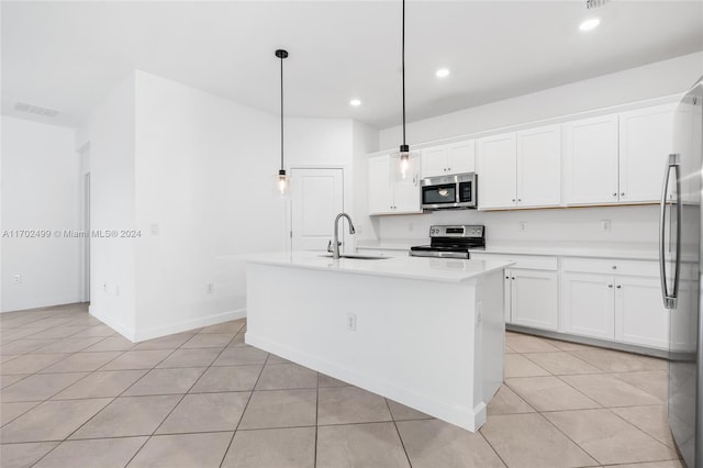 kitchen featuring pendant lighting, white cabinetry, sink, a kitchen island with sink, and stainless steel appliances