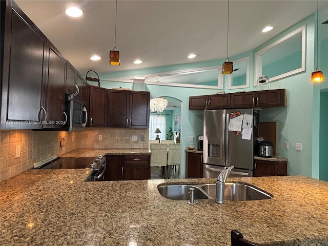 kitchen with appliances with stainless steel finishes, hanging light fixtures, and sink