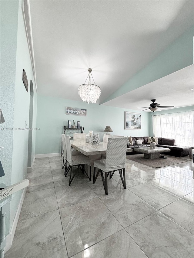 dining space with ceiling fan with notable chandelier