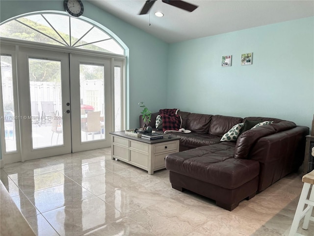 living room with french doors, a wealth of natural light, and ceiling fan