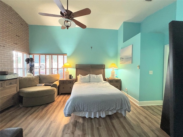 bedroom featuring hardwood / wood-style flooring, ceiling fan, and lofted ceiling