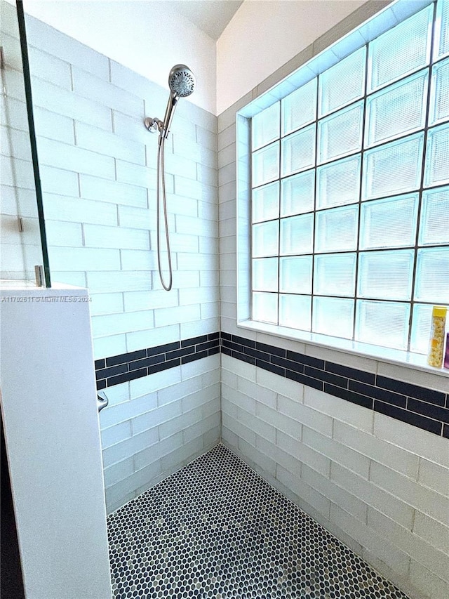 bathroom with tiled shower