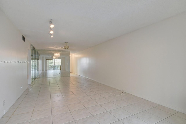 unfurnished room featuring ceiling fan and light tile patterned flooring