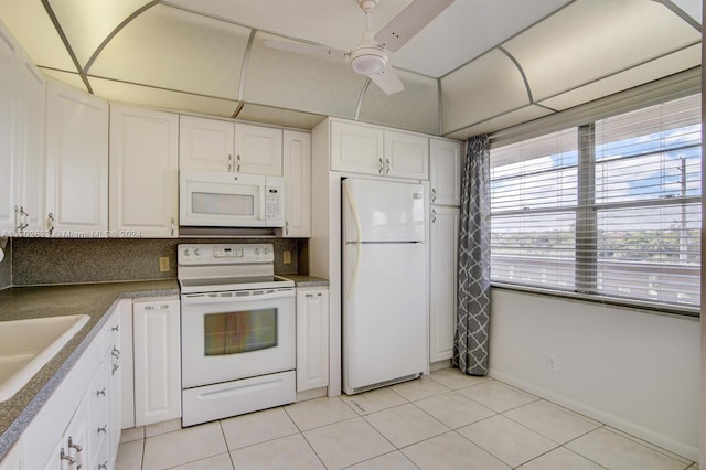 kitchen with white cabinets, white appliances, tasteful backsplash, and light tile patterned flooring