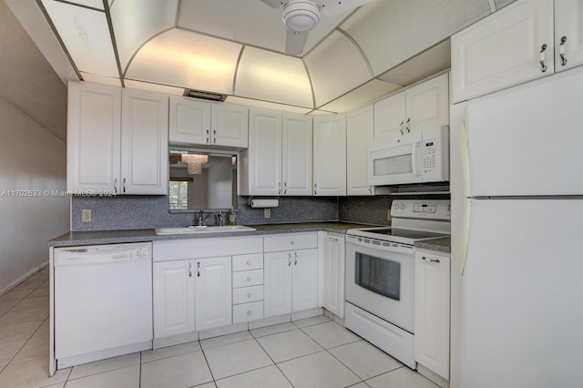 kitchen with light tile patterned floors, white appliances, white cabinetry, and sink