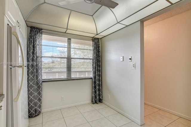 tiled empty room with ceiling fan