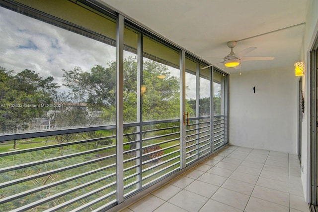 unfurnished sunroom featuring ceiling fan