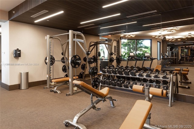 workout area featuring ceiling fan and carpet floors