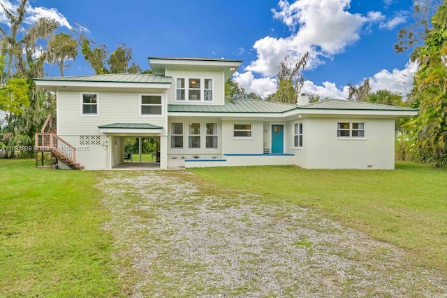 671 Live Oak Ln, La Belle, FL 33935 - back of property featuring a yard, driveway, metal roof, and a carport