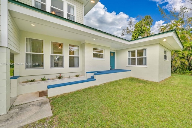 671 Live Oak Ln, La Belle, FL 33935 - rear view of house featuring a lawn