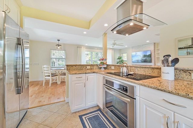 671 Live Oak Ln, La Belle, FL 33935 - kitchen with island exhaust hood, appliances with stainless steel finishes, light tile patterned floors, light stone counters, and white cabinetry