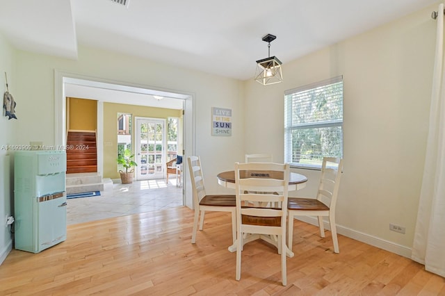 dining space with plenty of natural light and light hardwood / wood-style flooring