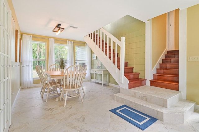671 Live Oak Ln, La Belle, FL 33935 - dining room featuring baseboards, stairs, and visible vents