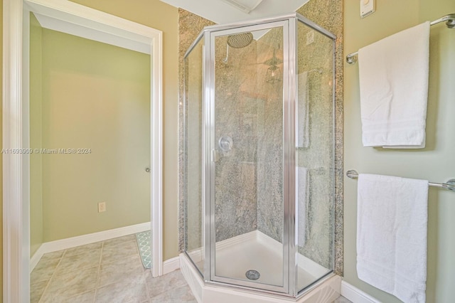 bathroom featuring tile patterned floors and a shower with shower door