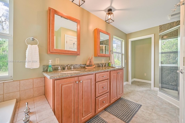 bathroom featuring vanity, a shower with door, tile patterned floors, and plenty of natural light