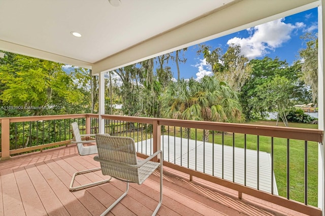 wooden deck featuring a yard