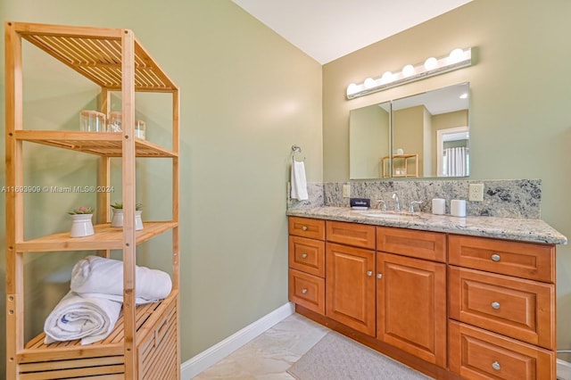 bathroom featuring tasteful backsplash and vanity