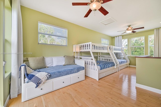 bedroom featuring multiple windows, ceiling fan, and light wood-type flooring