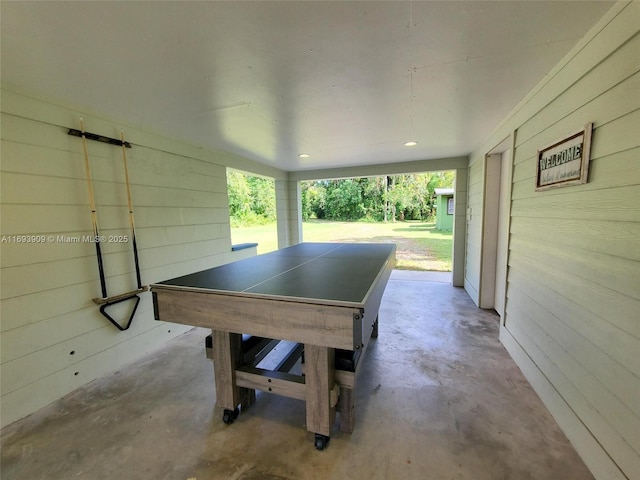 671 Live Oak Ln, La Belle, FL 33935 - recreation room with wooden walls and unfinished concrete flooring