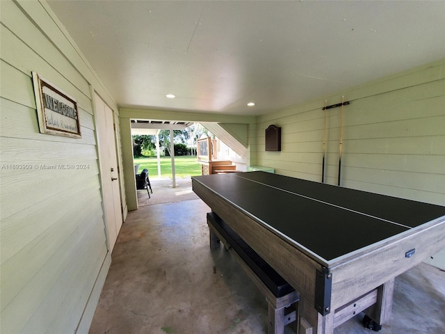 interior space with wooden walls and concrete flooring