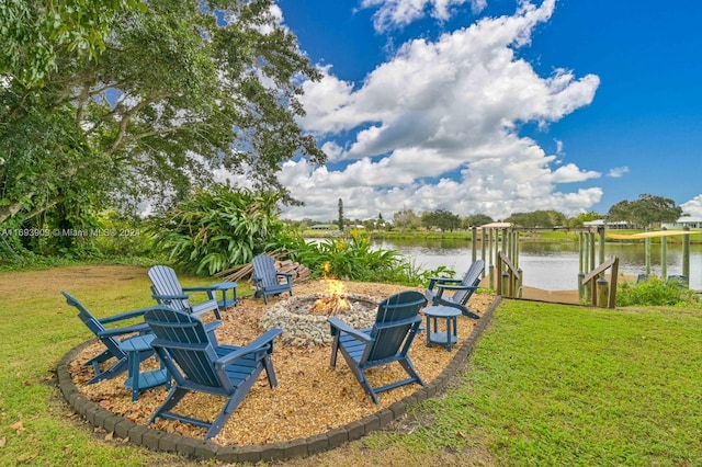 view of yard with a water view and an outdoor fire pit