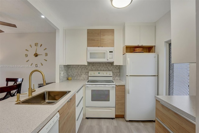 4451 NW 16th St Unit K204, Lauderhill, FL 33313 - kitchen with white appliances, a sink, light countertops, decorative backsplash, and light wood finished floors