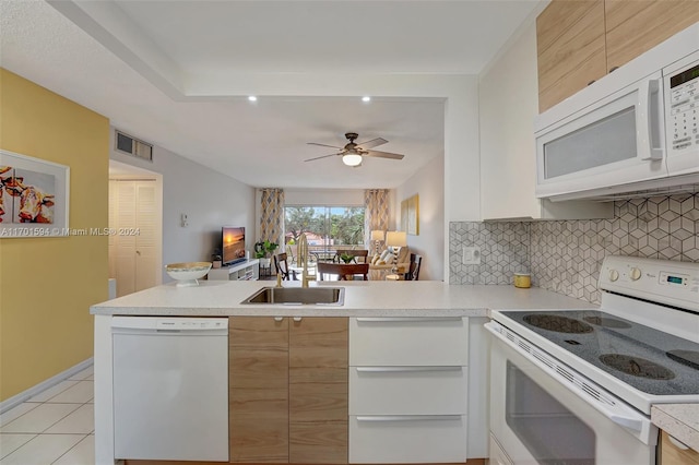 kitchen with white cabinets, white appliances, and kitchen peninsula