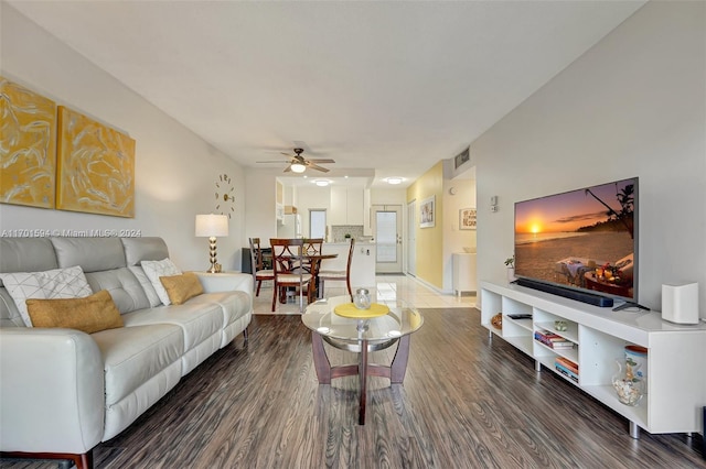 living room featuring ceiling fan and hardwood / wood-style flooring