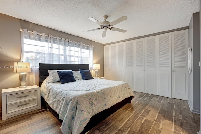 bedroom featuring ceiling fan, a closet, a textured ceiling, and hardwood / wood-style flooring