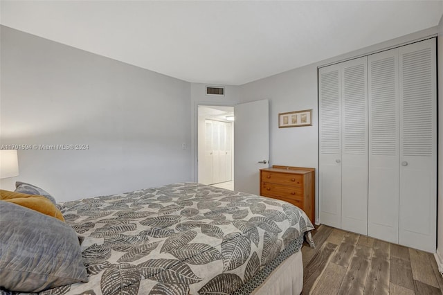 bedroom featuring wood-type flooring and a closet