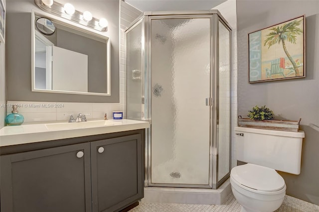 bathroom with vanity, tile patterned floors, toilet, walk in shower, and tasteful backsplash