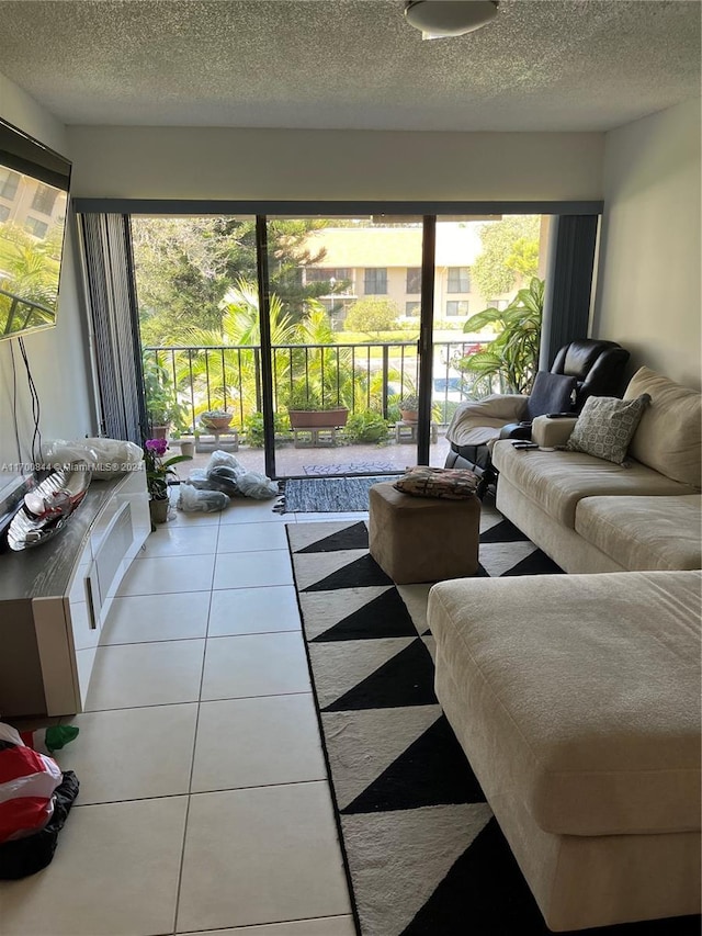 tiled living room with plenty of natural light and a textured ceiling