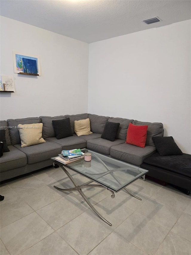 living room with light tile patterned floors and a textured ceiling