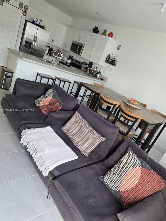 tiled living room with lofted ceiling