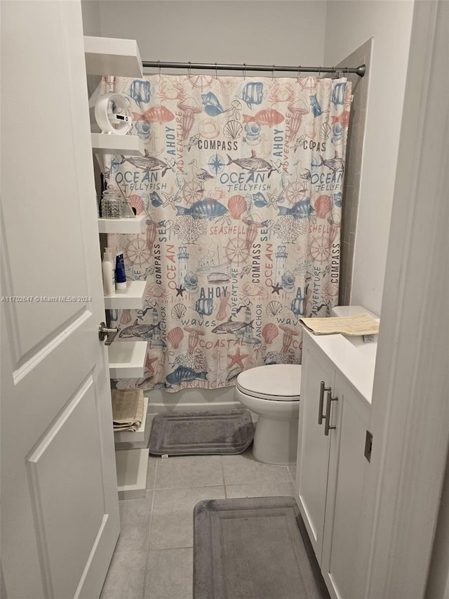 full bathroom with tile patterned flooring, shower / bath combination with curtain, vanity, and toilet