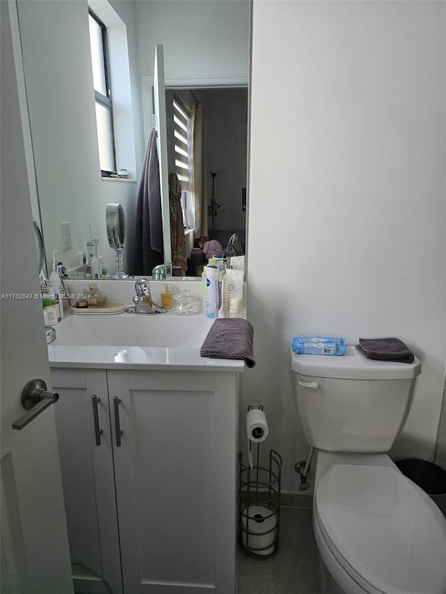 bathroom featuring tile patterned floors, vanity, and toilet