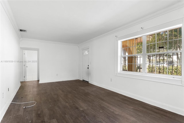 unfurnished room with baseboards, wood finished floors, visible vents, and ornamental molding