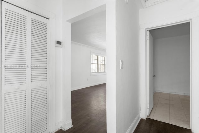 hallway with dark wood-style floors and baseboards