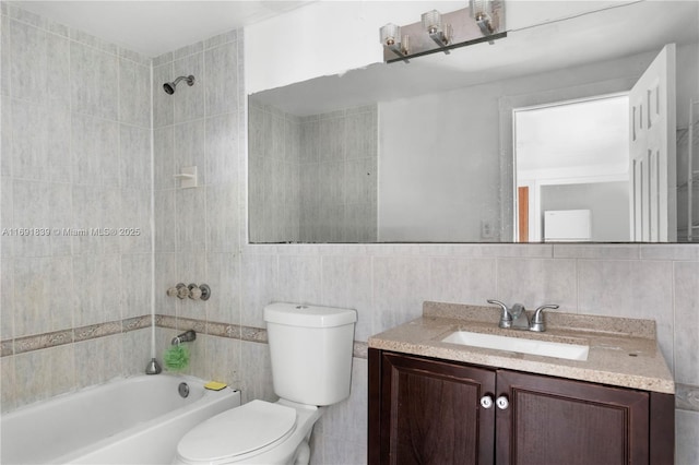 bathroom with vanity, tile walls, toilet, and shower / washtub combination