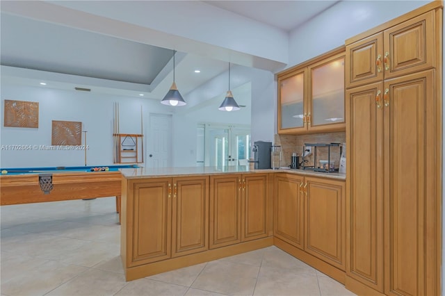 kitchen featuring backsplash, pool table, decorative light fixtures, light tile patterned flooring, and kitchen peninsula