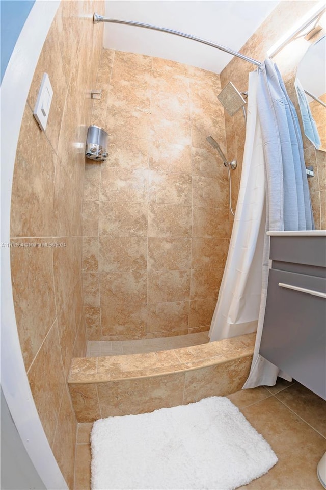 bathroom with tile patterned flooring and walk in shower