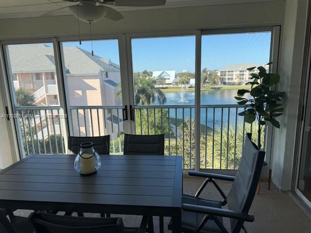 sunroom / solarium with a water view