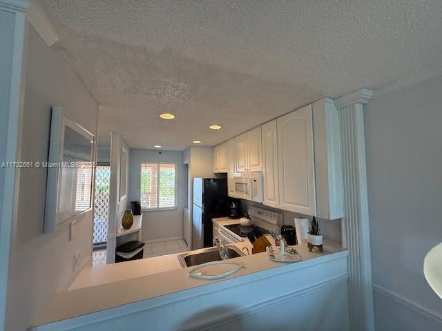 kitchen featuring white cabinetry, sink, white appliances, and a textured ceiling