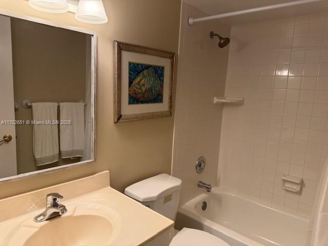 full bathroom featuring shower / bath combination with curtain, vanity, and toilet